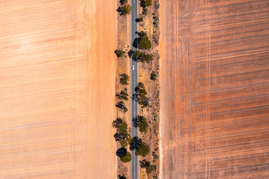 Aerial drone view of car on a road in the countryside, Western Australia