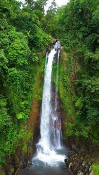 Aerial view of Gitgit waterfall with Balinese gate, Buleleng, Bali, Indonesia