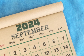 September 2024 calendar flat lay in blue background with copy space.