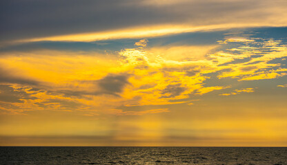 Enjoy a panoramic view of the skyline. The sun rises in the morning sky with colorful clouds. and beautiful cloud patterns In the soft light of the morning at sea
