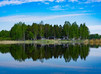Scenic view of the lake and forest against the blue sky