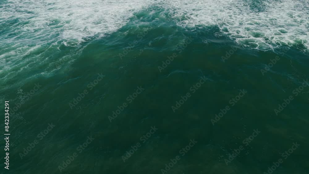Poster aerial view of green ocean waves with white foam patterns