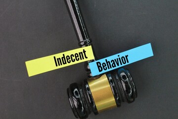 judge's gavel and colored paper with the word indecent behavior