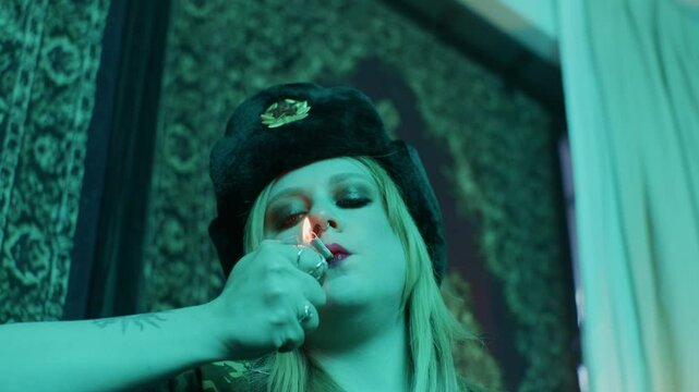 the face  russian woman girl female model artist smokes cigarette  in dark room with authentic soviet style