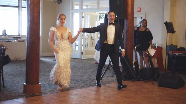 Bride and groom enter reception