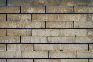 The surface of the beige brick wall. An old weathered brick. Stone texture with space to copy. High quality photo