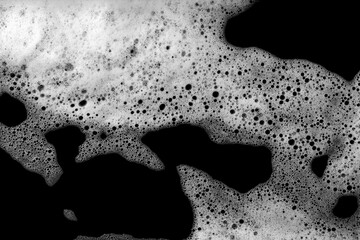 Liquid white foam bubble isolated on black background.