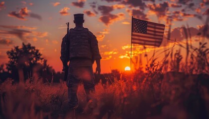 A lone soldier stands in silhouette against a vibrant sunset, the American flag waving proudly behind him.