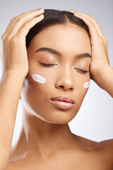 Naklejka premium Calm, face and woman with sunscreen for skincare and dermatology in studio background. Model, relax and girl with moisturizer lotion on skin for healthy glow or cream for natural beauty and cosmetics