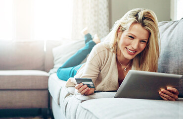 Lounge, woman and tablet with credit card, happy in payment for subscription or online shopping as...