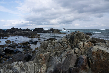 View of the rocky beach on a cloudy day