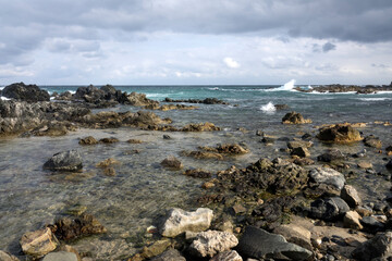 View of the rocky beach on a cloudy day