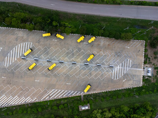 Aerial view of the electric bus charging station. Yellow electric city bus charging parking at...