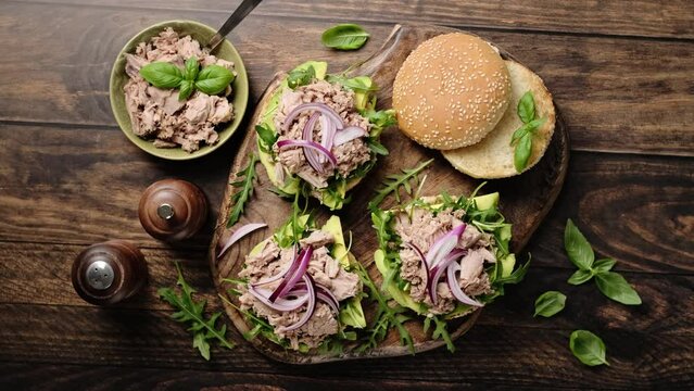 Canned tuna open sandwiches. Buns burgers with canned tuna, arugula and avocado. Stock footage video 4k