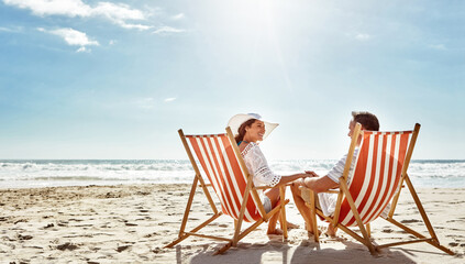 Couple, relax and beach chairs on sand for vacation, holiday or weekend break. Summer, man and...