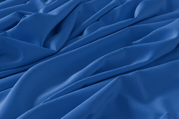 Obraz premium A detailed close-up shot of royal blue fabric with soft folds and creases, creating a textured and elegant background.