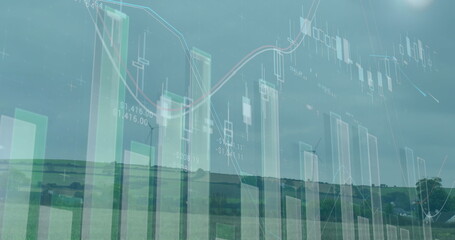 Image of graphs and financial data over wind turbine