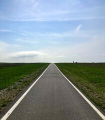 Modern paved road to horizon line under blue sky. Landscape. New path concept