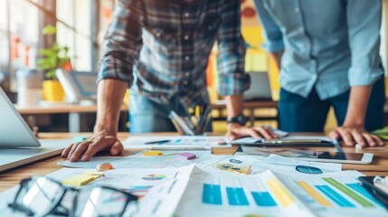 A collaborative team environment in a business office, with documents and laptop indicating project work