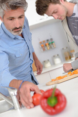 a man reaching for tomatos