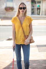 young blind woman crossing road
