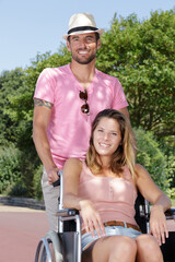Naklejka premium peaceful handicapped young couple in wheelchairs in park