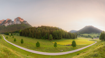 Meadow with road and bench during sunset in Berchtesgaden National Park