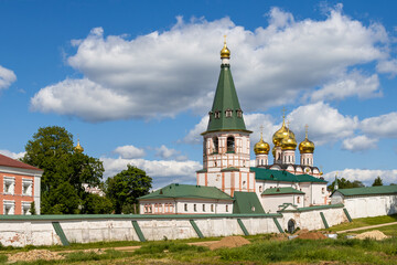 Valday Iversky Monastery, Valday (Valdai), Novgorod region, Russia. View of the monastery wall, bell tower and golden domes of the Cathedral of the Iveron Icon of the Mother of God. Travel in Russia.