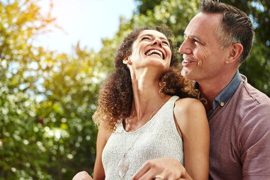 Smile, couple and hug with laughter at funny joke for marriage with humor, and happiness in nature. Excited, husband and wife with love embrace or chuckle for support and time together on honeymoon