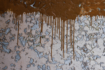 Peeling paint on the wall. Old concrete wall with cracked flaking paint. Weathered rough painted...