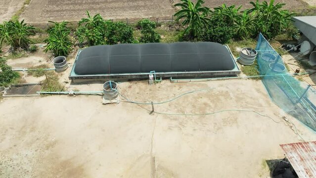 Covered lagoon digester for biogas production from small pig farm.
