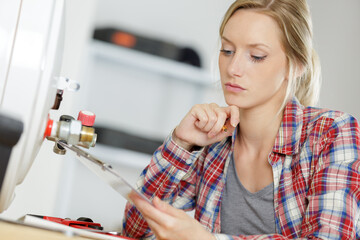 woman engineer checking technical data of heating system