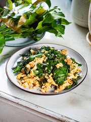 Bai Liang Pad Kai, stir fried Malindjo or Baegu leaves with egg, popular Thai southern dish
