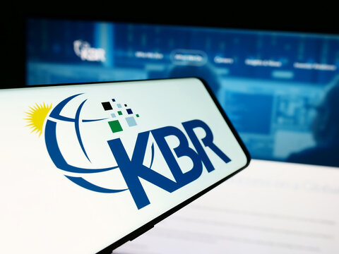 Stuttgart, Germany - 05-27-2024: Smartphone with logo of American engineering and construction company KBR Inc. in front of website. Focus on center-left of phone display.