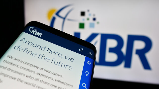 Stuttgart, Germany - 05-27-2024: Mobile phone with website of US engineering and construction company KBR Inc. in front of business logo. Focus on top-left of phone display.