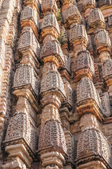 Ancient architectural stone carvings of Mandakini Temple with intricate artistry and historical...