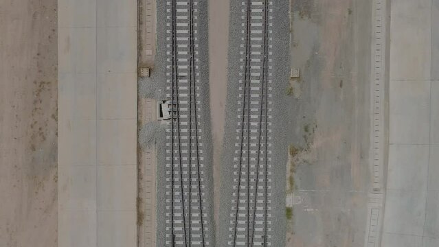 The construction of the unfinished railway line, a lot of stones on the side of the tracks.