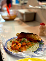 Shrimp Tacos - Authentic Mexican Street Tacos made with Shrimp in Red Sauce and Served on Tortillas with Onions, Cilantro, Lime and a Burnt Crunchy Tortilla on Top. Seafood. Puerto Vallarta, Mexico.