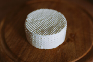 round feta cheese on wooden board