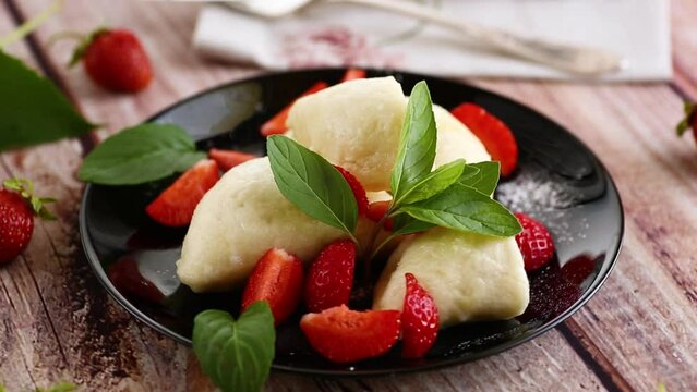 cooked sweet homemade steamed dumplings with strawberries