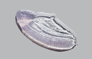 Cosmetic shimmering scrub pink texture smudge gel peeling swatch on gray background