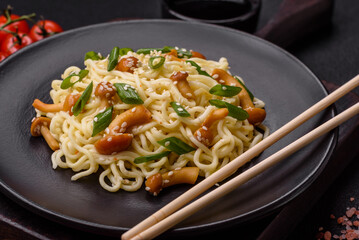 Delicious Asian cuisine dish with rice noodles, peppers, mushrooms and spices