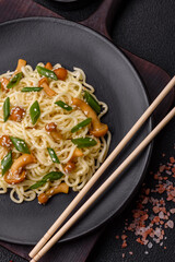 Delicious Asian cuisine dish with rice noodles, peppers, mushrooms and spices