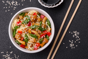 Delicious Asian cuisine dish with rice noodles, peppers, mushrooms and spices