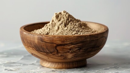 High-detail image of Tinospora crispa powder in a simple wooden bowl, showcasing the contrast between the powder's fine texture and the bowl's rough surface