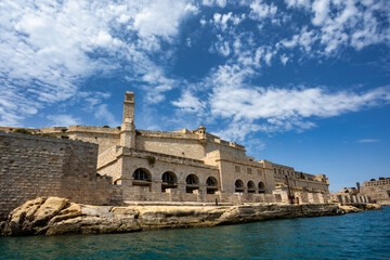 Fototapeta premium Fort St. Angelo, symbol of Malta's resilience, majestic stone walls, silent witness to rich history. Port in Birgu. Malta