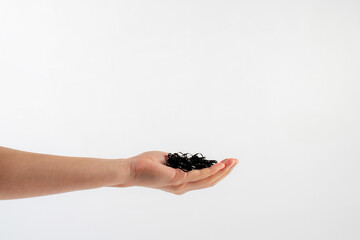 Black rubber band in hand isolated on white background