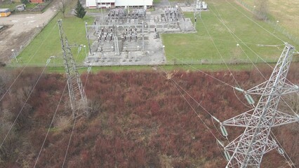 High voltage substation with tall pylons and distribution system cable wires. Aerial