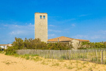Back and tower of the Notre-Dame des flots church of La Cotiniere in Saint-Pierre-d'Oléron, France