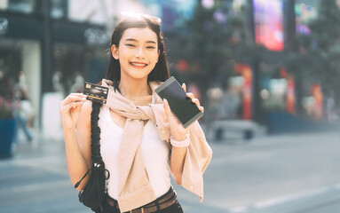 Portrait young beautiful face asian woman holding credit card and smartphone city lifestyles